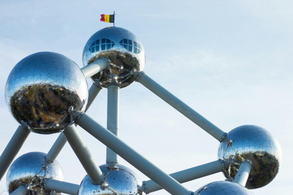 pexels-photo-3847431-3847431 The Atomium in Brussels, a striking modern architectural landmark with metallic spheres under a blue sky.