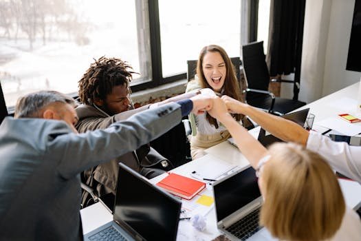 pexels-photo-7792804-7792804-2 A diverse group of professionals celebrate a successful meeting with a fist bump.